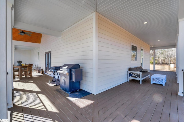 deck with an outdoor living space and a grill