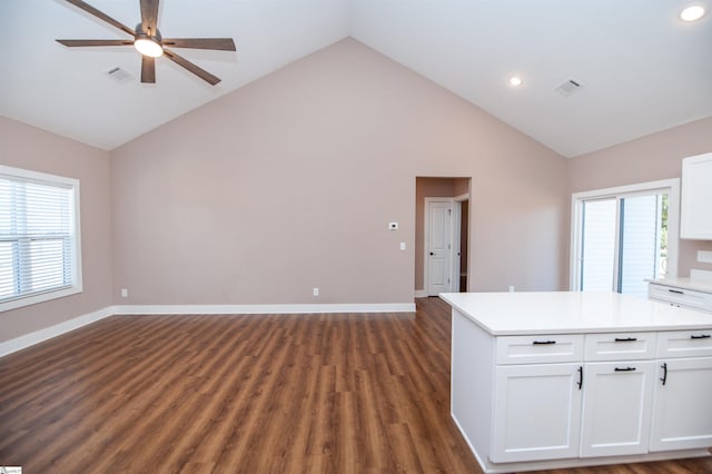 interior space featuring ceiling fan, high vaulted ceiling, white cabinets, and dark hardwood / wood-style flooring