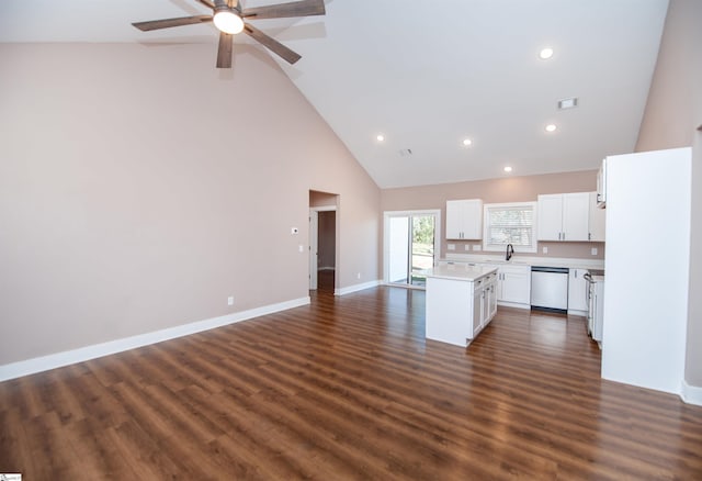 kitchen with high vaulted ceiling, dark hardwood / wood-style floors, a center island, white cabinets, and stainless steel dishwasher