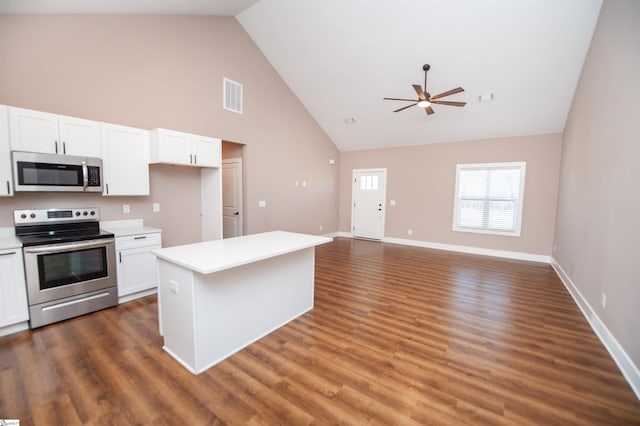 kitchen featuring white cabinetry, high vaulted ceiling, dark hardwood / wood-style floors, stainless steel appliances, and a center island