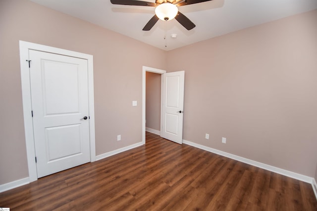 unfurnished bedroom with dark wood-type flooring and ceiling fan