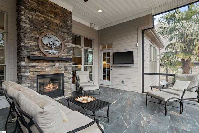 view of patio featuring an outdoor living space with a fireplace