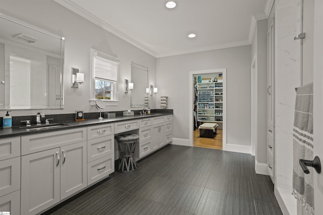 bathroom featuring vanity, a shower, and crown molding