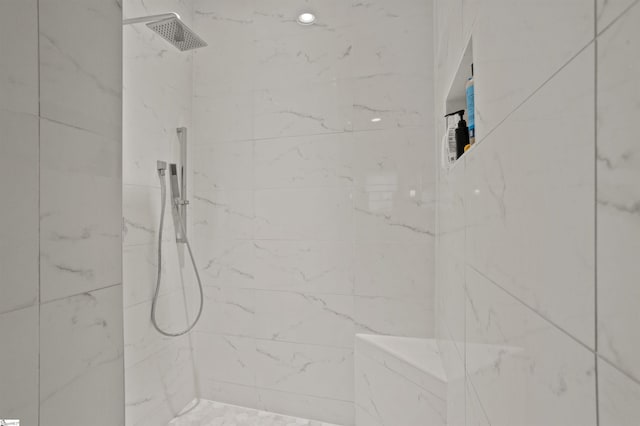 bathroom with a tile shower