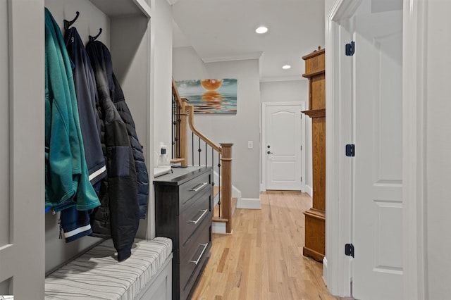 mudroom with crown molding and light hardwood / wood-style flooring