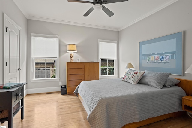 bedroom with ornamental molding, light wood-type flooring, and ceiling fan