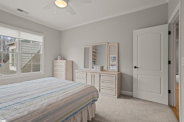 bedroom featuring ornamental molding, light carpet, and ceiling fan