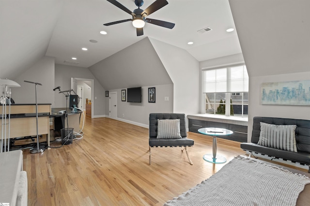 living area featuring ceiling fan, lofted ceiling, and light wood-type flooring