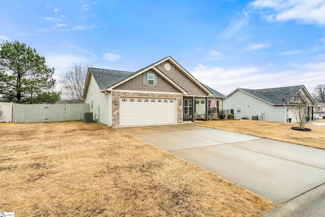 craftsman inspired home with central AC unit and a front yard