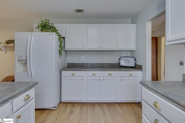 kitchen with white cabinetry, light hardwood / wood-style floors, and white fridge with ice dispenser