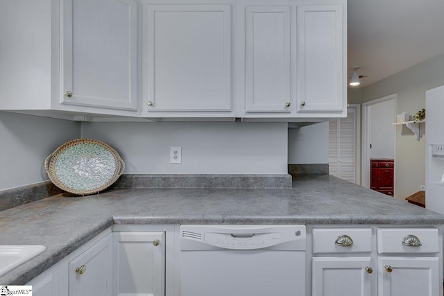 kitchen featuring white dishwasher and white cabinets