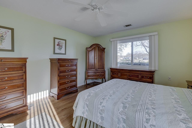 bedroom with light hardwood / wood-style floors and ceiling fan