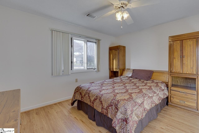 bedroom with light hardwood / wood-style floors and ceiling fan