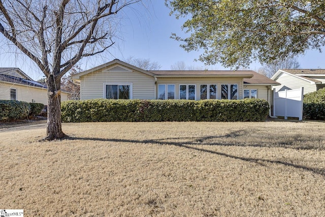 single story home featuring a front lawn