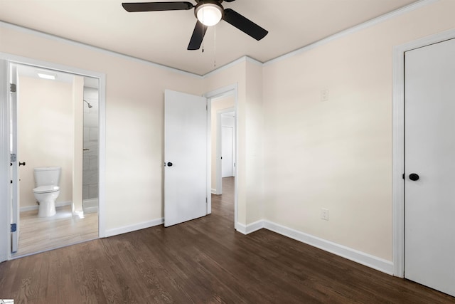 unfurnished bedroom with crown molding, ceiling fan, ensuite bathroom, and dark hardwood / wood-style flooring