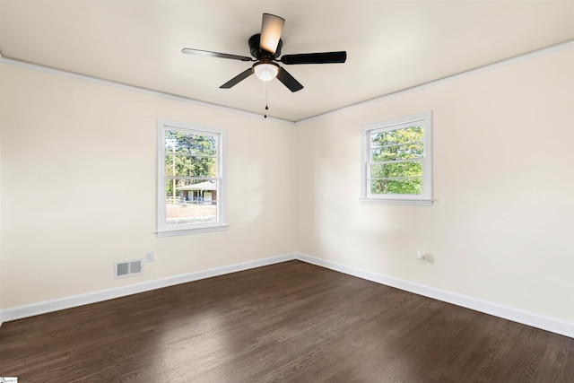 spare room with ceiling fan, a healthy amount of sunlight, and dark hardwood / wood-style floors