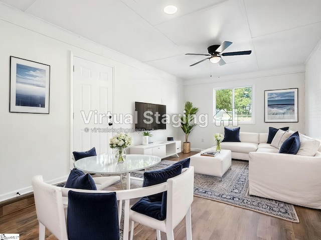 living room with hardwood / wood-style flooring, ceiling fan, and ornamental molding