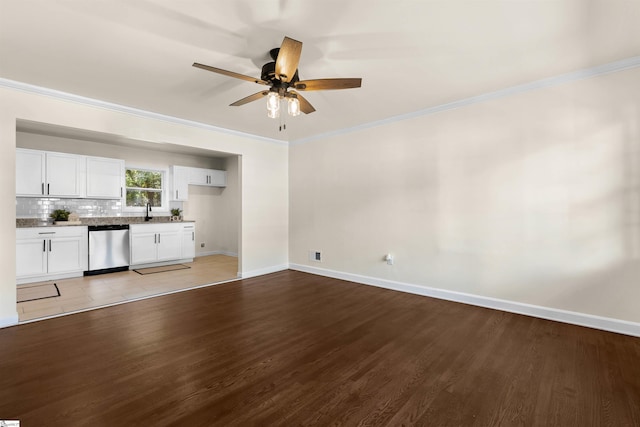 unfurnished living room with crown molding, ceiling fan, sink, and light wood-type flooring