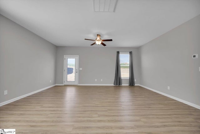 empty room with ceiling fan and light wood-type flooring