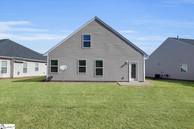 back of property with a yard and a patio area