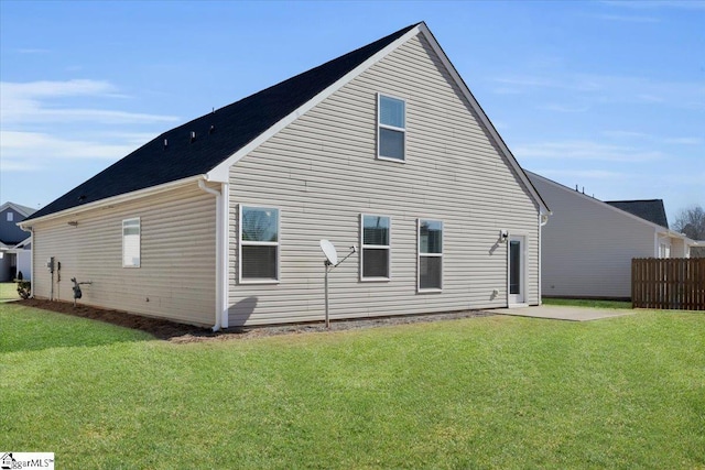 back of property featuring a yard and a patio area