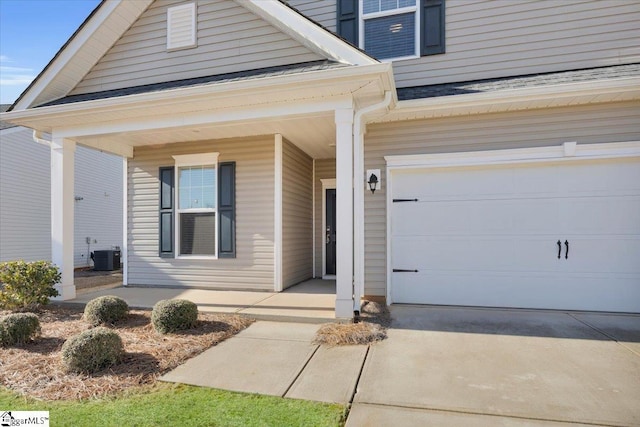 view of front facade with a porch, a garage, and central AC unit