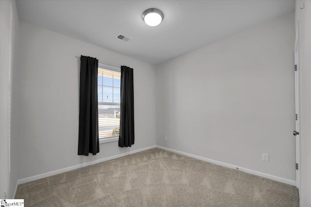 unfurnished room featuring light colored carpet