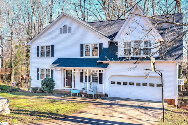 view of front of property with a garage, a porch, and a front yard