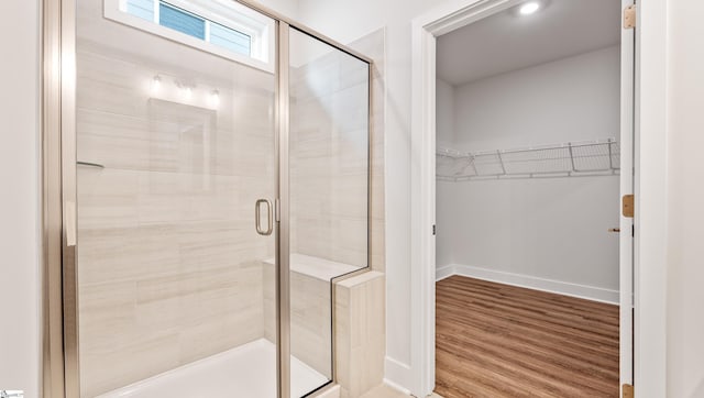312 Fiery Rd Lot 0170, Mauldin, SC 29607 - bathroom with a shower stall, wood finished floors, a walk in closet, and baseboards