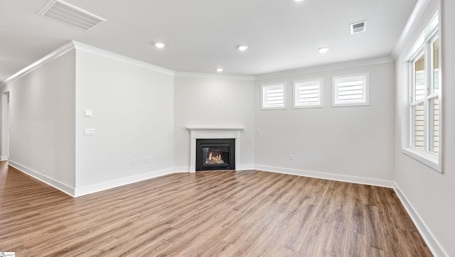 312 Fiery Rd Lot 0170, Mauldin, SC 29607 - unfurnished living room with ornamental molding, wood finished floors, a glass covered fireplace, plenty of natural light, and baseboards