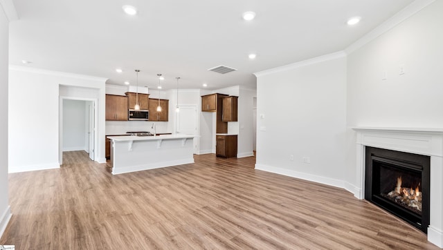 312 Fiery Rd Lot 0170, Mauldin, SC 29607 - unfurnished living room with a lit fireplace, light wood-style floors, recessed lighting, crown molding, and baseboards