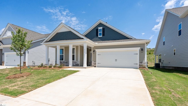 312 Fiery Rd Lot 0170, Mauldin, SC 29607 - craftsman house with covered porch, a front lawn, concrete driveway, stone siding, and a garage
