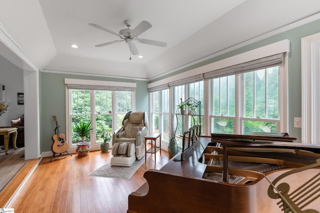 sunroom with ceiling fan, plenty of natural light, and vaulted ceiling