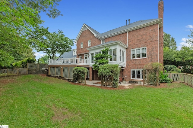 rear view of house with a yard, a deck, and a patio