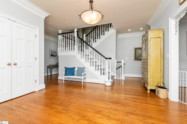 foyer entrance featuring hardwood / wood-style flooring and ornamental molding