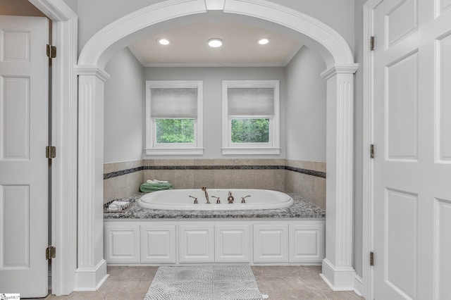 bathroom with a washtub, tile patterned flooring, and crown molding