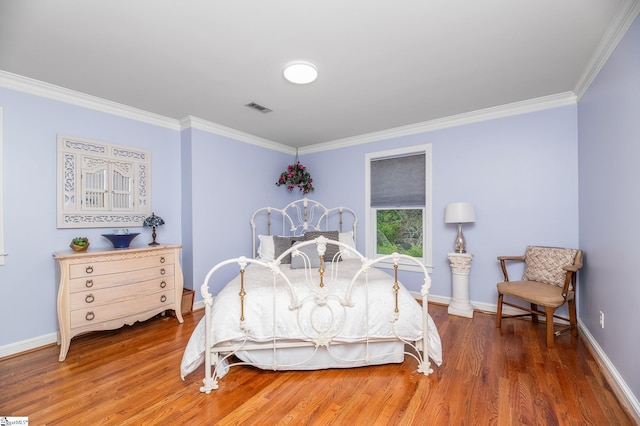 bedroom with crown molding and dark hardwood / wood-style floors