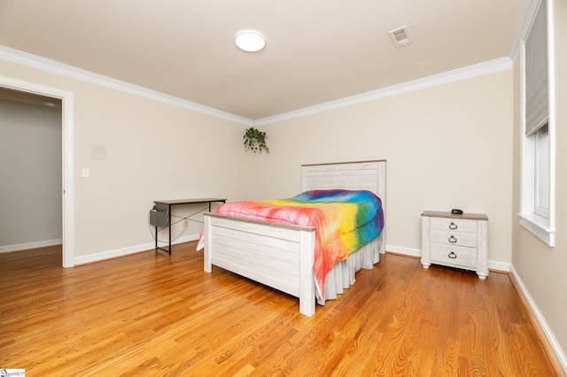 bedroom with wood-type flooring and ornamental molding