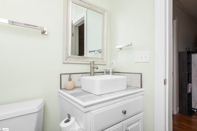 bathroom featuring vanity, toilet, and hardwood / wood-style floors