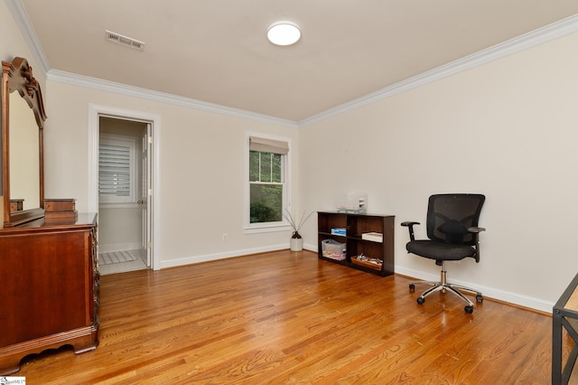 sitting room with ornamental molding and light hardwood / wood-style floors