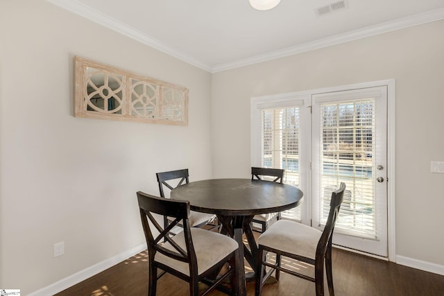 dining area featuring crown molding and dark hardwood / wood-style floors