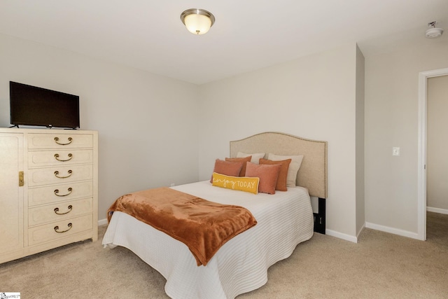 bedroom featuring light carpet