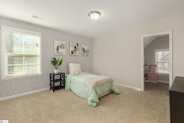 carpeted bedroom with lofted ceiling