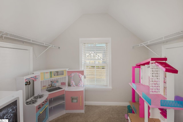 interior space featuring carpet floors, lofted ceiling, and sink