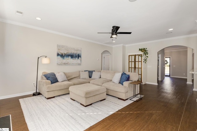 living room with ceiling fan, ornamental molding, and wood-type flooring