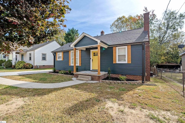 bungalow-style house with a front lawn