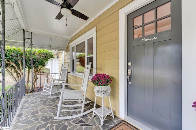 entrance to property featuring covered porch and ceiling fan