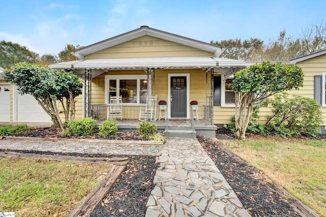 bungalow-style home featuring a porch and a garage