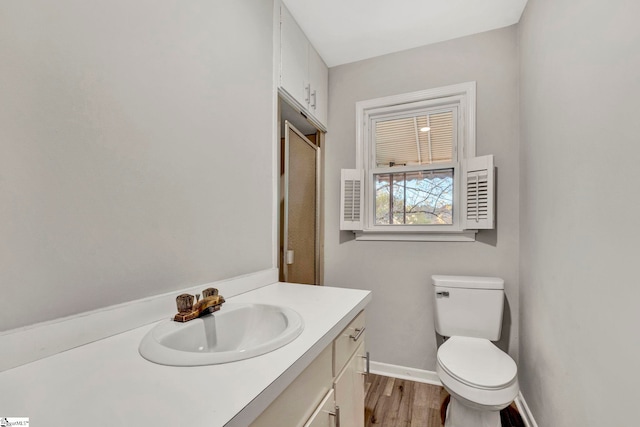 bathroom featuring vanity, toilet, and wood-type flooring