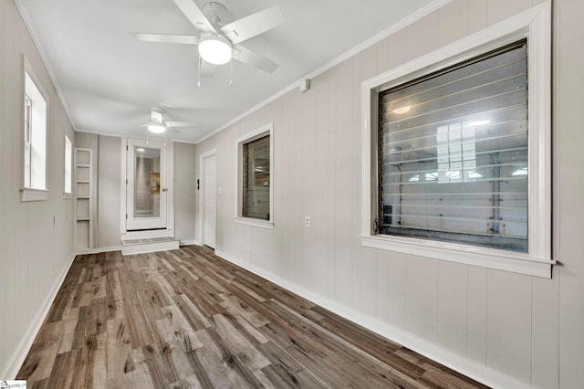 spare room with hardwood / wood-style flooring, ornamental molding, and ceiling fan